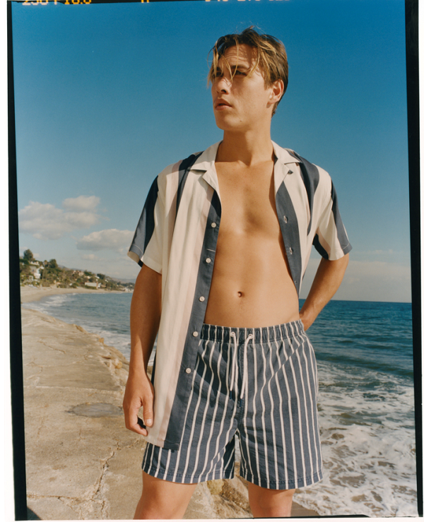 A man with striped swimming shorts