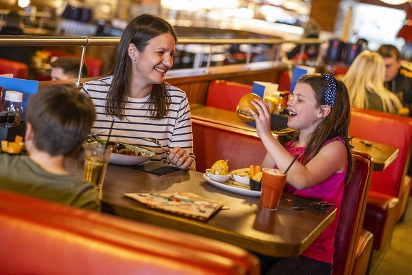 Family enjoying a meal in a diner booth