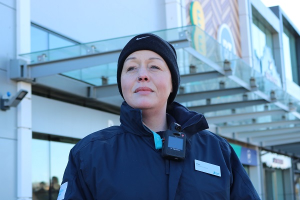 Kim, wearing a security officer uniform and a wooly hat