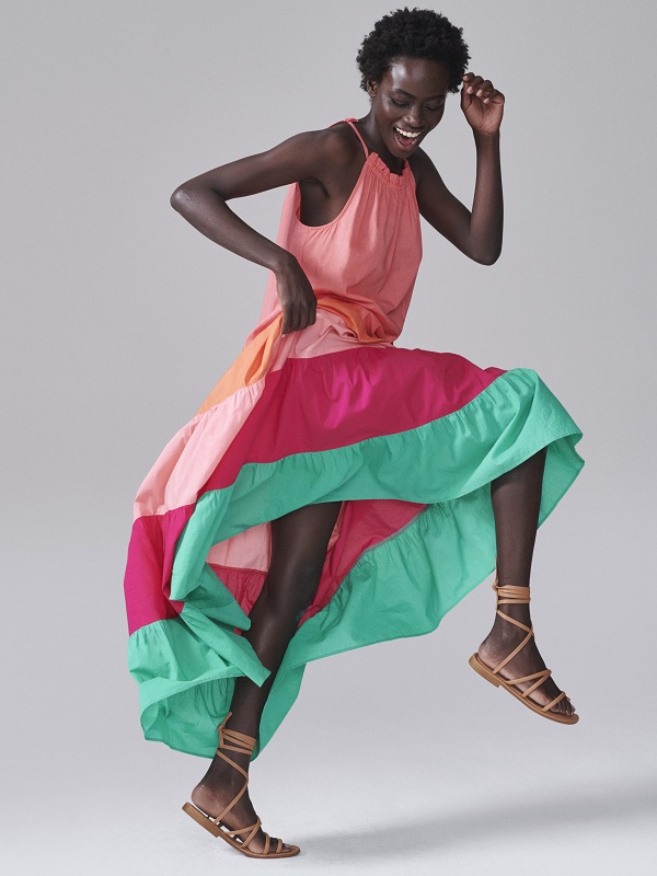 A model wearing long colourful dress