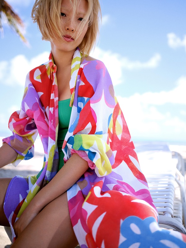 A model wearing a patterned swim cover up