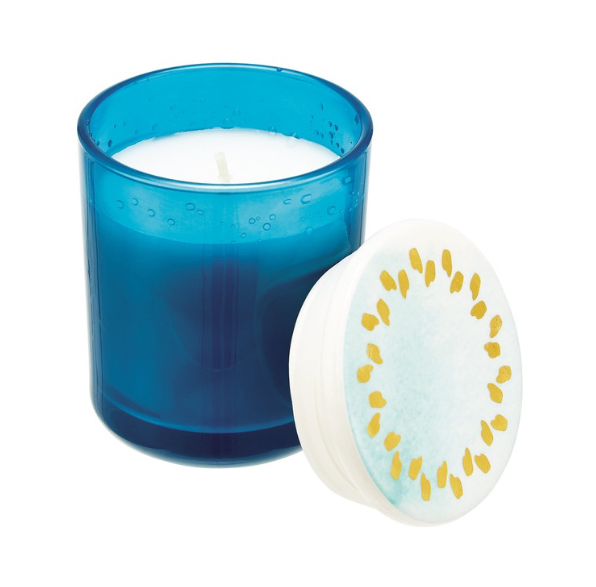 A white candle in a blye glass